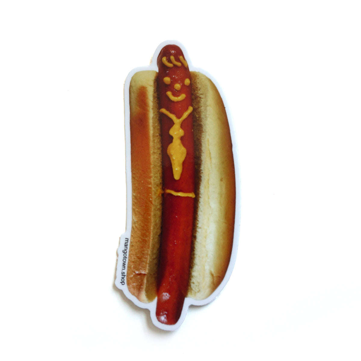 A die cut sticker of a hotdog with a smiley face and tie drawn on with mustard