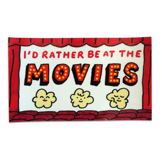 Sticker that says "Id' rather be at the movies" with 3 illustrated popcorn characters underneath the text with theater curtains and seats along the borders